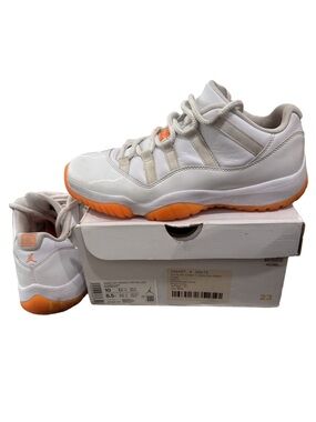 Jordan Woman's Air Jordan 11 Retro White and Orange Low Top Athletic Sneakers